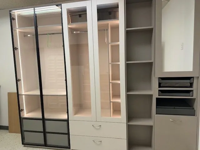 Finished fitted wardrobe with glass doors and interior lighting