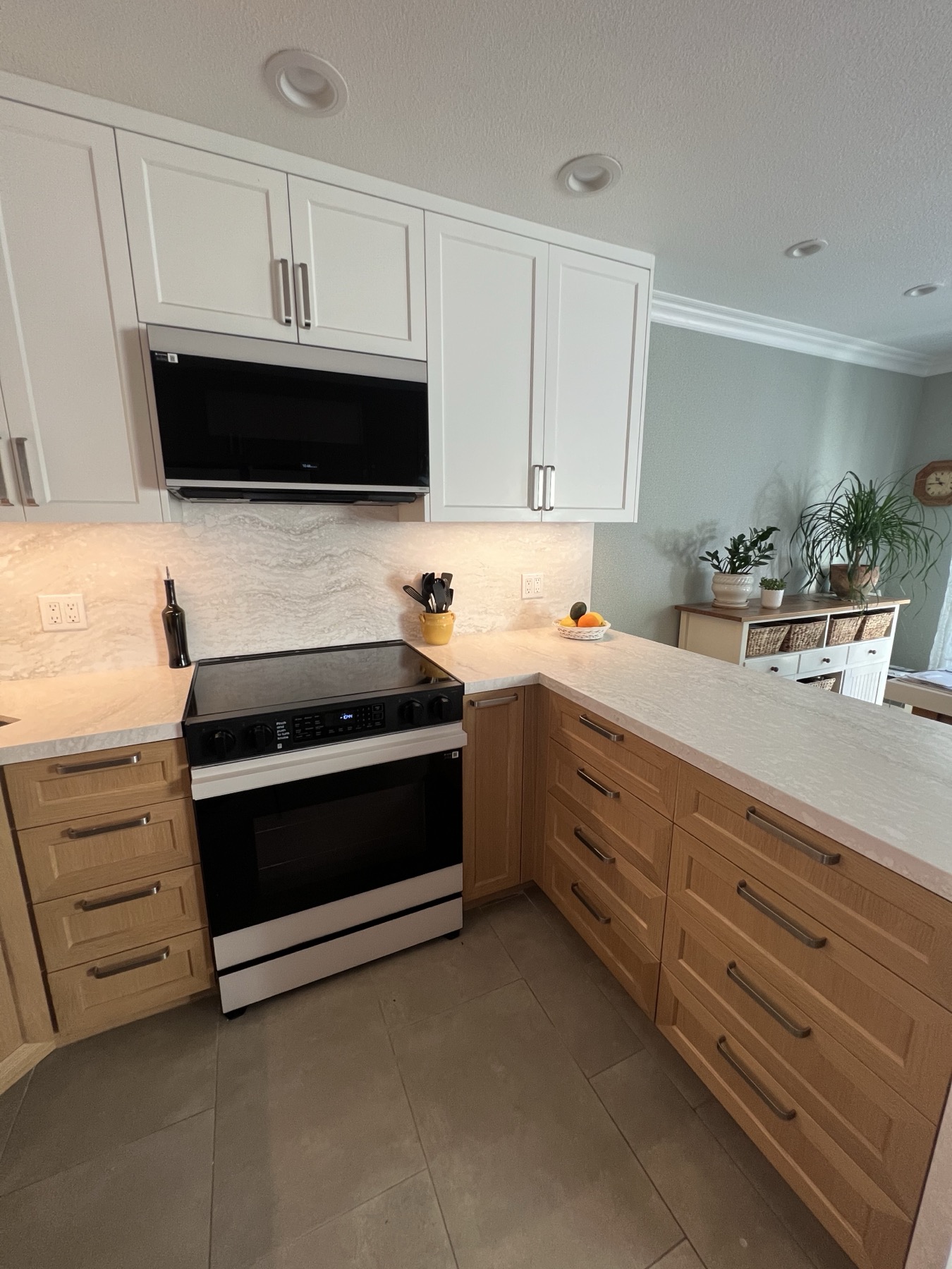 Warm-wood base cabinets and drawer banks on both sides of the range