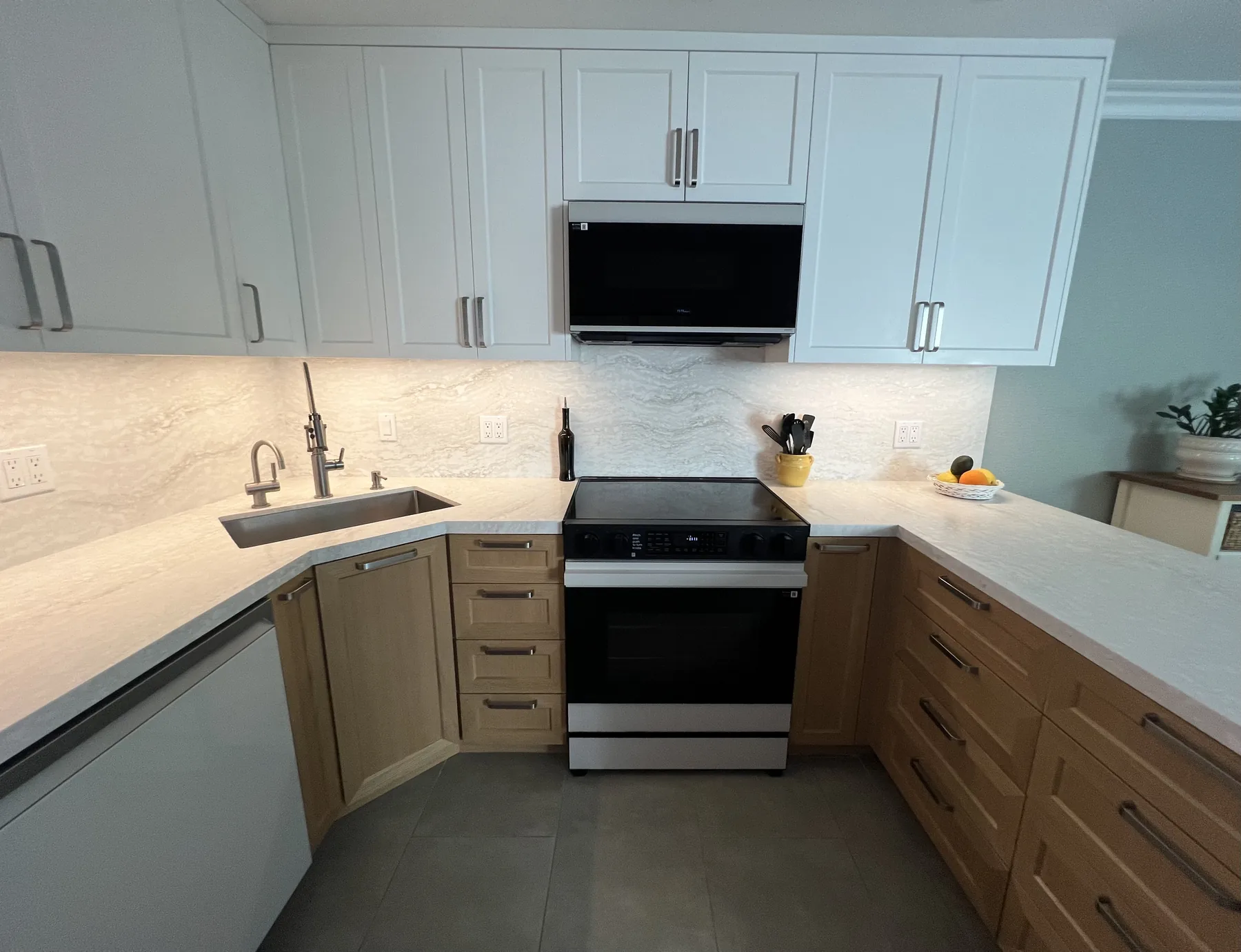 Warm-wood custom kitchen with white uppers and a peninsula