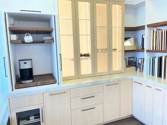 Kitchen display with a coffee station, glass-front cabinets and lower storage